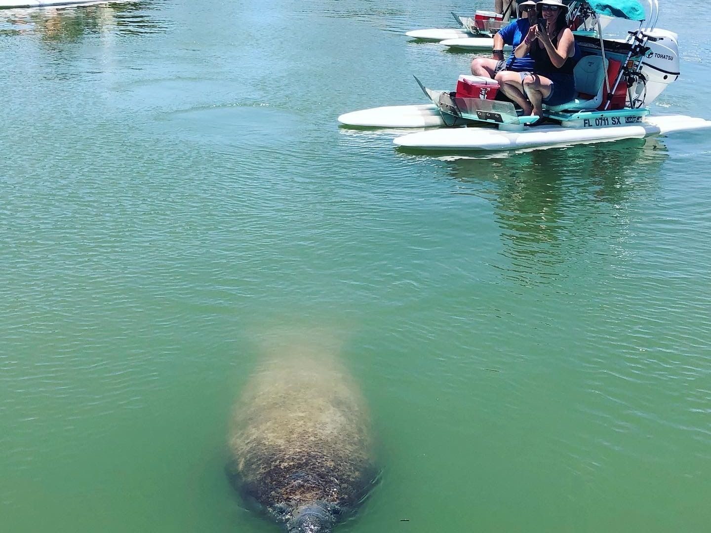 a group of people on a boat in the water
