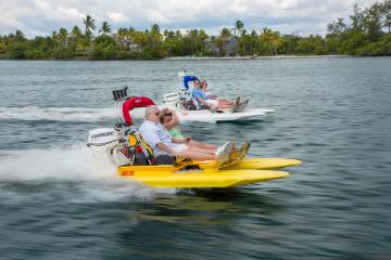 a person riding on the back of a boat in a body of water